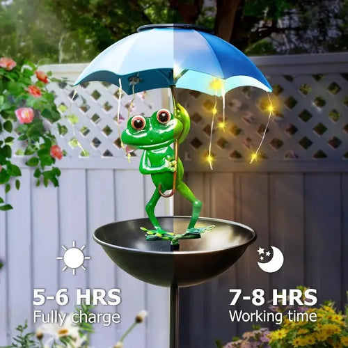 Frog under an umbrella with solar panel, surrounded by plants and flowers.