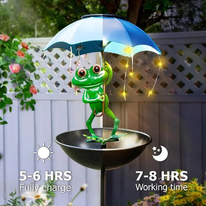 Frog under an umbrella with solar panel, surrounded by plants and flowers.