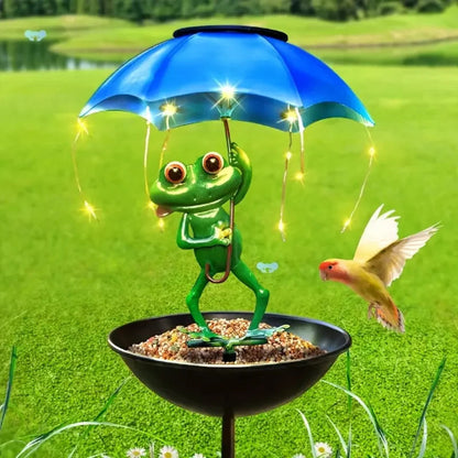 Frog with a blue umbrella and string lights on a grassy background